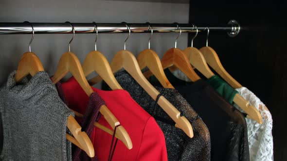Hangers with Different Clothes in Wardrobe Closet