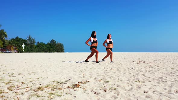 Women sunbathing on marine bay beach holiday by aqua blue ocean with clean sand background of Koh Ph