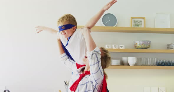 Mother and son pretending to be superhero in living room 4k