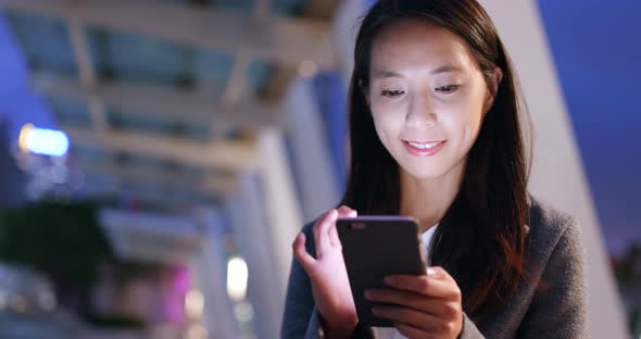 Businesswoman use of cellphone at night