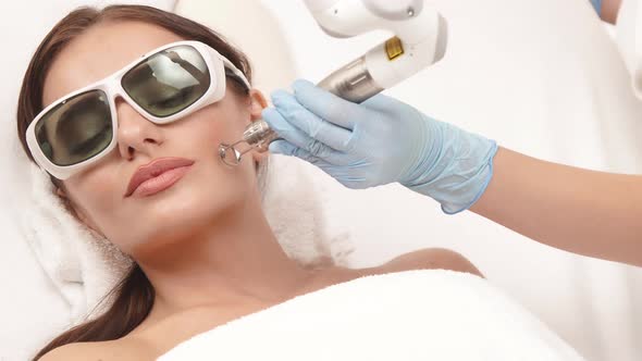 Erbium Laser Theraphy on Female Face at Spa Clinic