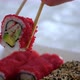 The Girl's Hand Takes Colorful Sushi and Dips It in Soy Sauce - VideoHive Item for Sale