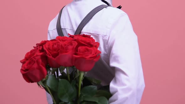 Confident Boy Hiding Roses Behind Back