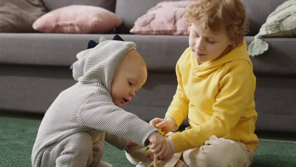 Little Kids Playing Stacking Toy at Home