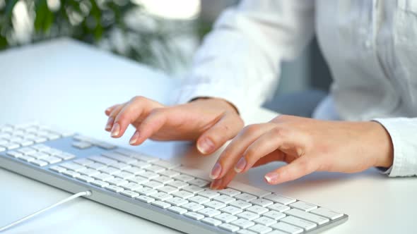 Female Hands Busy Working on Computer Keyboard for Sending Emails and Surf on a Web Browser