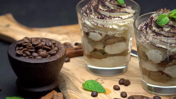 Classic Tiramisu Dessert in a Glass on Dark Concrete Background