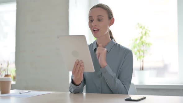Online Video Chat on Tablet By Woman in Office