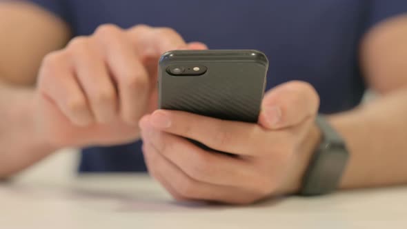 Close Up of Male Hands Using Smartphone