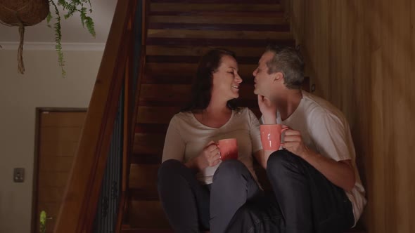 Couple at home together on the stairs