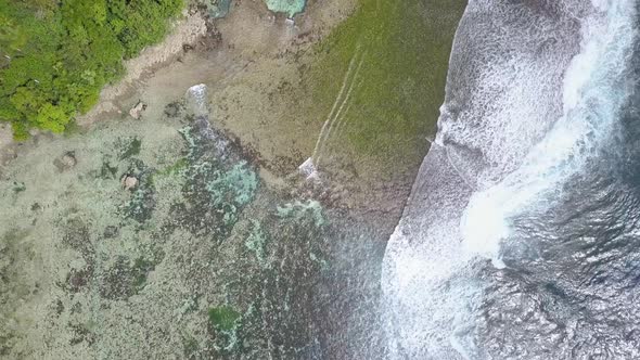 Aerial dolly of Magpupungko Rock Pools at high tide at Siargao, the Philippines