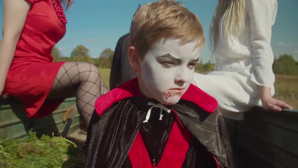 Sad Kid in Halloween Costume Sitting in Trailer