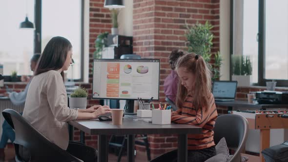 Business Man Drawing with Child on Notebook While Woman Working