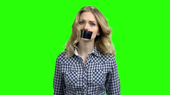 Caucasian Woman Protester with Tape on Mouth.