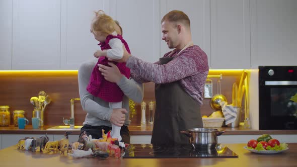 Happy Same-sex Family with Baby Bonding in Kitchen