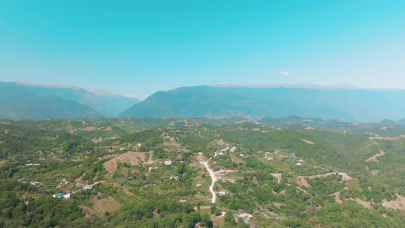 Aerial  View Moving Forward To Pine Woods Forest and Mountain