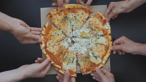 Top view of People  hands taking Slices pizza.  Friends eating together.