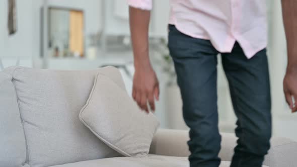 African Man Sitting on Sofa and Opening Laptop 