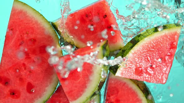 Super Slow Motion Shot of Falling Fresh Watermelon Slices Into Water at 1000Fps.