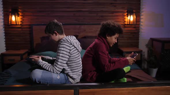 Mixed Race Teens Playing Video Games on Phones