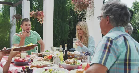 Happy family eating together at table