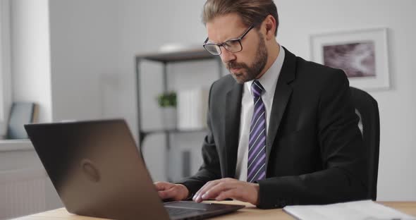 Office Worker Typing on Wireless Laptop