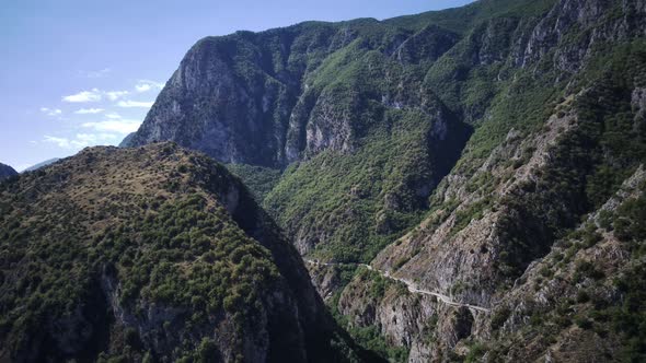 Aerial View Around a Bare Valley Amidst Mountains and Foliage in Sunny Abruzzo