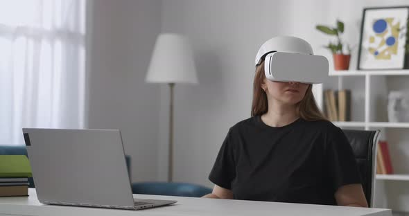 Modern Gadget for Watching Virtual Reality Woman Is Using Headmounted Display in Room Looking Around