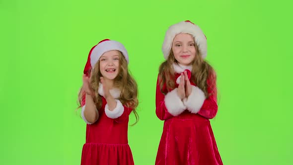 Children in Red New Year Hats Watch a Fairy Tale in the Theater and Clap Their Hands. Green Screen