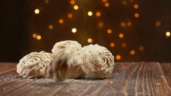 Meringue Nut Cookies are Falling on a Wooden Surface