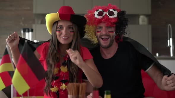 Excited German soccer Fan Couple Cheering for Germany