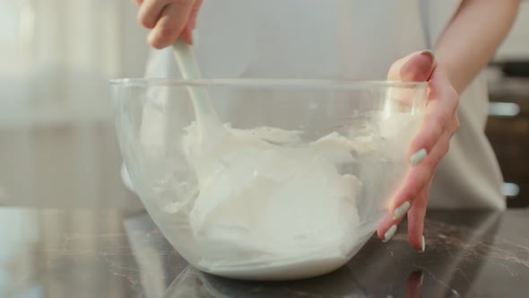 General Shot of Mixing Cheese Cream for Birthday Cake in a Glass Bowl