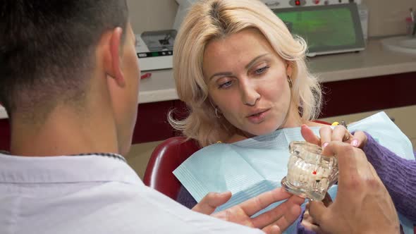 Attractive Mature Woman Talking To the Dentist at His Office