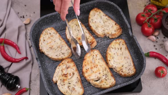 Toasting Slices of Baguette in a Grill Frying Pan