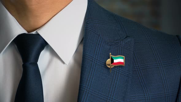 Businessman Walking Towards Camera With Country Flag Pin Kuwait