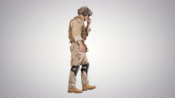 Military Man Marine Walking and Using Radio on Gradient Background.