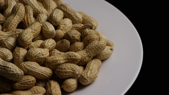 Cinematic, rotating shot of peanuts on a white surface - PEANUTS 022