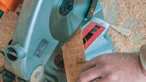 Carpenter Using Circular Saw for Cutting Wooden Boards alt