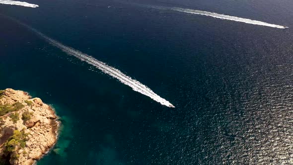 Aerial footage of jet speed boats in the ocean, taken around the island of Ibiza in Spain