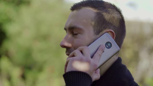 Young Man Talking on Smartphone Outdoor