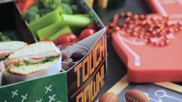 Football Snack Stadium filled with sub sandwiches, veggies and chips.