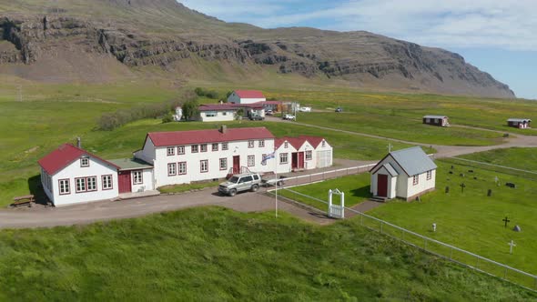 Aerial View Orbit Around Typical Building in Countryside of Iceland with Small Church and Cemetery