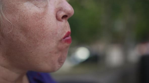 Obese Woman Eats Bun at the Street