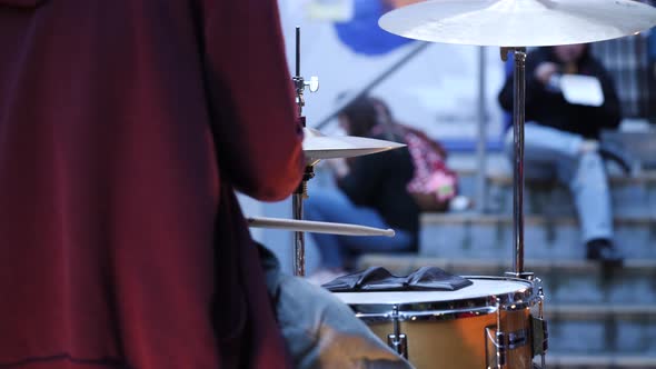 Drummer performing at a street fair.