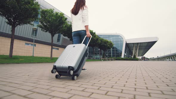 Woman Walking with Luggage. The Girl Goes on a Journey and Walks To the Airport. A Businesswoman