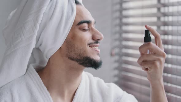 Funny Hispanic Bearded Indian Man with White Bath Towel on Head in Bathroom Beauty Procedures