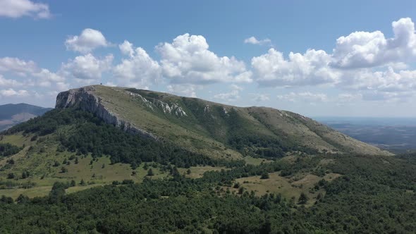 Clouds passing over the valley and the top of Stol mountain 4K drone video