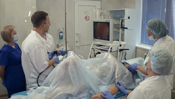 Medical Team Conducting Surgery Using Endoscope
