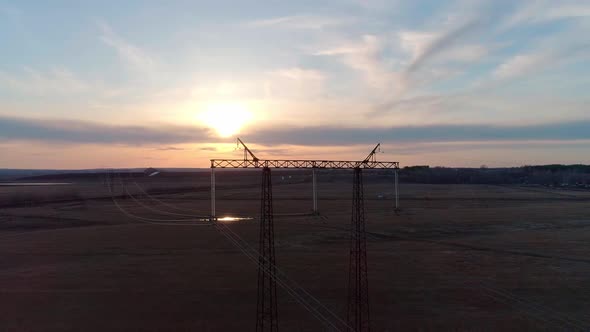 Aerial Video of the Electric Pole with Wires Against Sky at Sunset