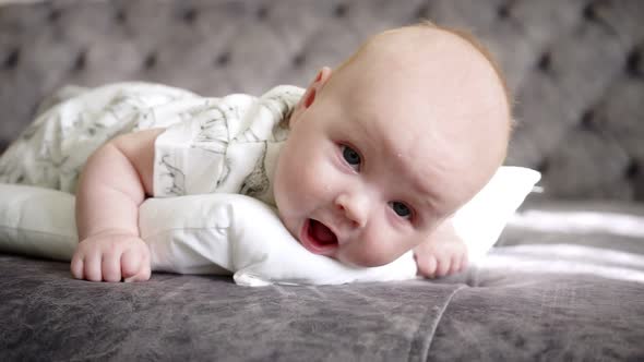 Baby Lies on Her Stomach and Looks at Camera