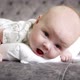 Baby Lies on Her Stomach and Looks at Camera - VideoHive Item for Sale